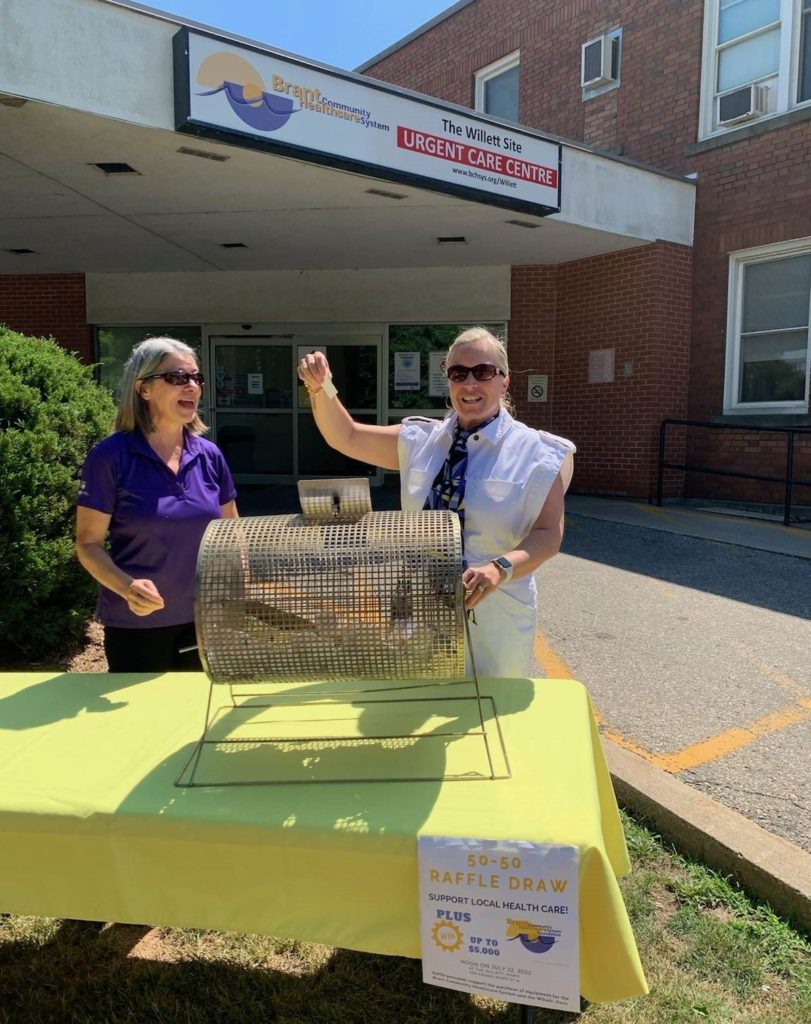 Susan Morton, President of the Paris & District Chamber of Commerce (left), joined Brant Community Healthcare System Foundation Board Chair Heather Wilson (right) today at The Willett, pictured pulling the lucky ticket for our recent special 50-50 Draw.